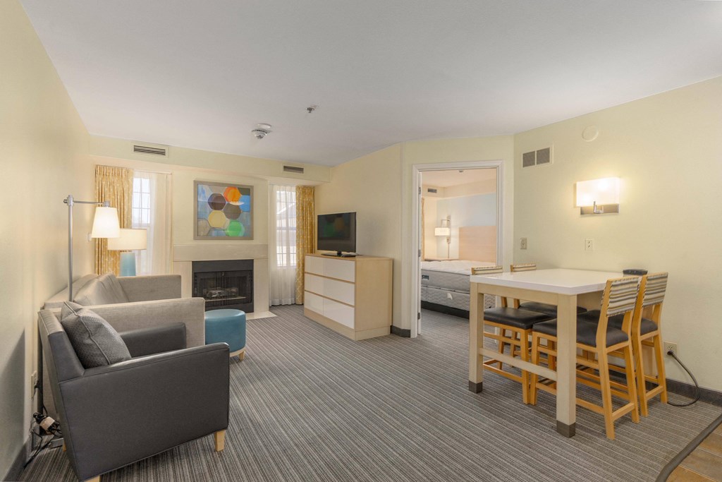 a living room and dining area in a hotel room